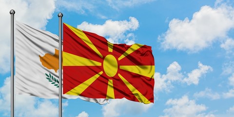 Cyprus and Macedonia flag waving in the wind against white cloudy blue sky together. Diplomacy concept, international relations.
