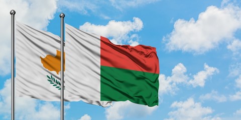 Cyprus and Madagascar flag waving in the wind against white cloudy blue sky together. Diplomacy concept, international relations.