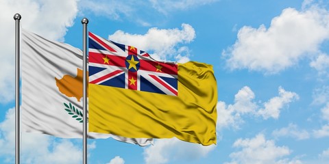 Cyprus and Niue flag waving in the wind against white cloudy blue sky together. Diplomacy concept, international relations.