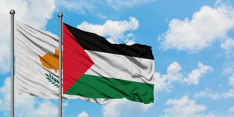 Cyprus and Palestine flag waving in the wind against white cloudy blue sky together. Diplomacy concept, international relations.