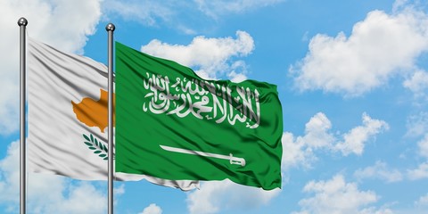 Cyprus and Saudi Arabia flag waving in the wind against white cloudy blue sky together. Diplomacy concept, international relations.