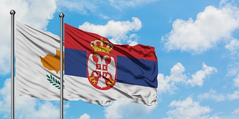 Cyprus and Serbia flag waving in the wind against white cloudy blue sky together. Diplomacy concept, international relations.