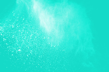 Fototapeta na wymiar Explosion of colored powder isolated on blue background. Abstract colored background. holi festival.