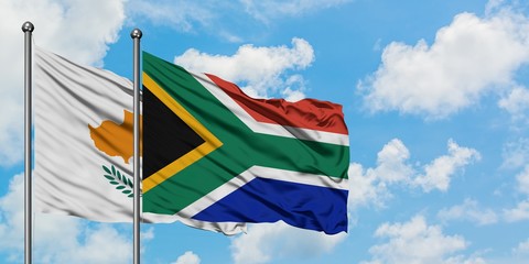 Cyprus and South Africa flag waving in the wind against white cloudy blue sky together. Diplomacy concept, international relations.