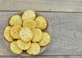 Plate of rice cracker on wooden table