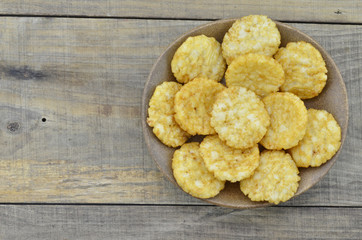 Plate of rice cracker on wooden background