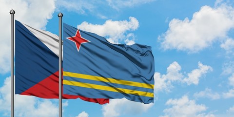Czech Republic and Aruba flag waving in the wind against white cloudy blue sky together. Diplomacy concept, international relations.