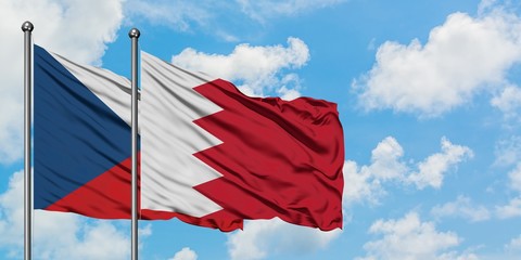 Czech Republic and Bahrain flag waving in the wind against white cloudy blue sky together. Diplomacy concept, international relations.