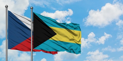 Czech Republic and Bahamas flag waving in the wind against white cloudy blue sky together. Diplomacy concept, international relations.