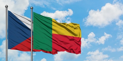 Czech Republic and Benin flag waving in the wind against white cloudy blue sky together. Diplomacy concept, international relations.