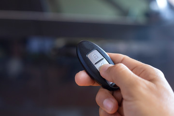Hand man hode car remote for open the car. Soft focus and focus selective remote.