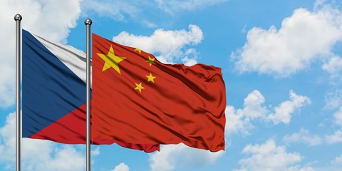 Czech Republic and China flag waving in the wind against white cloudy blue sky together. Diplomacy concept, international relations.