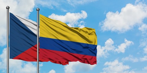 Czech Republic and Colombia flag waving in the wind against white cloudy blue sky together. Diplomacy concept, international relations.