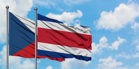 Czech Republic and Costa Rica flag waving in the wind against white cloudy blue sky together. Diplomacy concept, international relations.