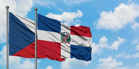 Czech Republic and Dominican Republic flag waving in the wind against white cloudy blue sky together. Diplomacy concept, international relations.