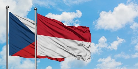 Czech Republic and Indonesia flag waving in the wind against white cloudy blue sky together. Diplomacy concept, international relations.