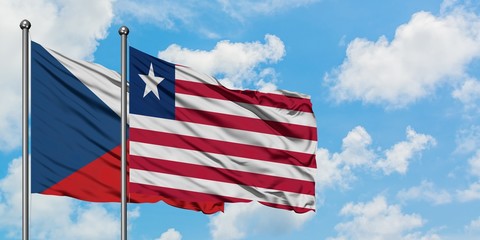 Czech Republic and Liberia flag waving in the wind against white cloudy blue sky together. Diplomacy concept, international relations.