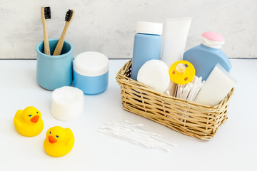 Baby bathroom cosmetics near pacifier and rubber duck on white background