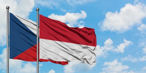 Czech Republic and Monaco flag waving in the wind against white cloudy blue sky together. Diplomacy concept, international relations.