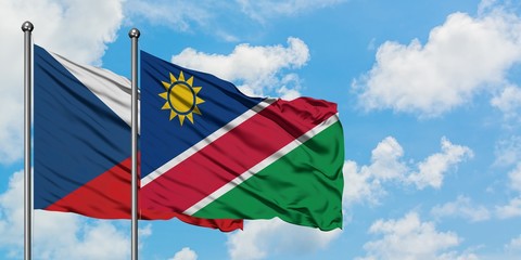 Czech Republic and Namibia flag waving in the wind against white cloudy blue sky together. Diplomacy concept, international relations.