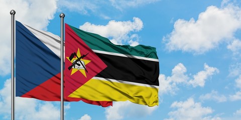 Czech Republic and Mozambique flag waving in the wind against white cloudy blue sky together. Diplomacy concept, international relations.