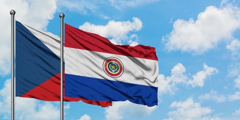 Czech Republic and Paraguay flag waving in the wind against white cloudy blue sky together. Diplomacy concept, international relations.