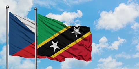 Czech Republic and Saint Kitts And Nevis flag waving in the wind against white cloudy blue sky together. Diplomacy concept, international relations.
