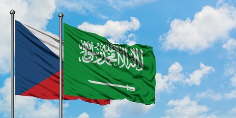 Czech Republic and Saudi Arabia flag waving in the wind against white cloudy blue sky together. Diplomacy concept, international relations.