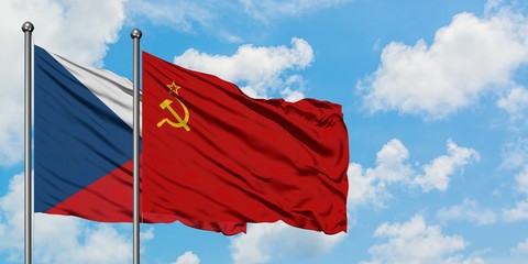 Czech Republic and Soviet Union flag waving in the wind against white cloudy blue sky together. Diplomacy concept, international relations.