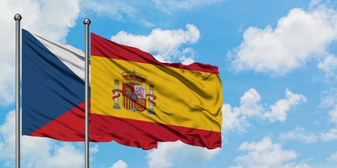 Czech Republic and Spain flag waving in the wind against white cloudy blue sky together. Diplomacy concept, international relations.