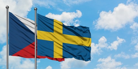 Czech Republic and Sweden flag waving in the wind against white cloudy blue sky together. Diplomacy concept, international relations.