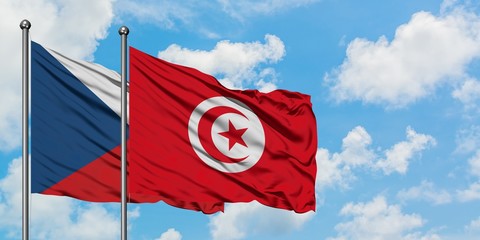 Czech Republic and Tunisia flag waving in the wind against white cloudy blue sky together. Diplomacy concept, international relations.