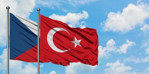 Czech Republic and Turkey flag waving in the wind against white cloudy blue sky together. Diplomacy concept, international relations.