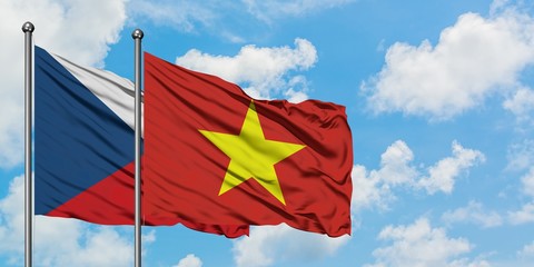 Czech Republic and Vietnam flag waving in the wind against white cloudy blue sky together. Diplomacy concept, international relations.