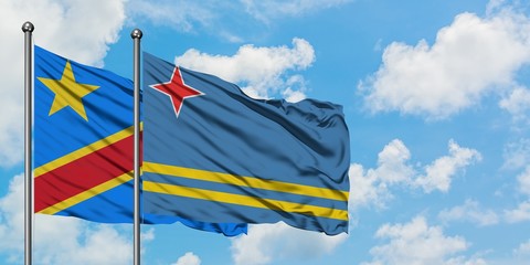 Congo and Aruba flag waving in the wind against white cloudy blue sky together. Diplomacy concept, international relations.