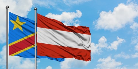 Congo and Austria flag waving in the wind against white cloudy blue sky together. Diplomacy concept, international relations.