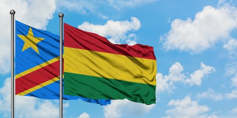 Congo and Bolivia flag waving in the wind against white cloudy blue sky together. Diplomacy concept, international relations.
