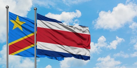 Congo and Costa Rica flag waving in the wind against white cloudy blue sky together. Diplomacy concept, international relations.