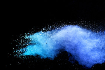 Blue sky color powder explosion on black background.
