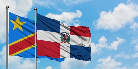Congo and Dominican Republic flag waving in the wind against white cloudy blue sky together. Diplomacy concept, international relations.