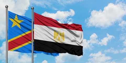 Congo and Egypt flag waving in the wind against white cloudy blue sky together. Diplomacy concept, international relations.