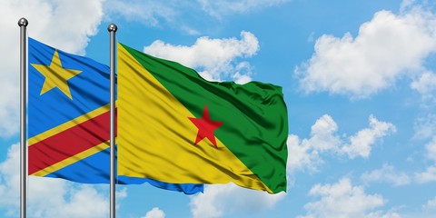Congo and French Guiana flag waving in the wind against white cloudy blue sky together. Diplomacy concept, international relations.