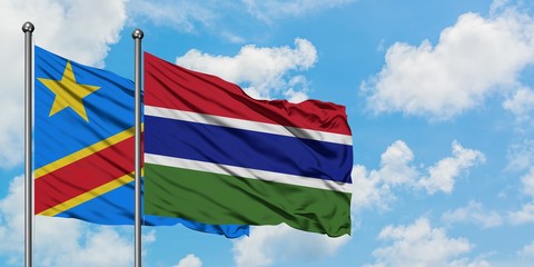 Congo and Gambia flag waving in the wind against white cloudy blue sky together. Diplomacy concept, international relations.