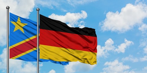 Congo and Germany flag waving in the wind against white cloudy blue sky together. Diplomacy concept, international relations.