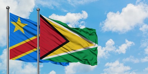 Congo and Guyana flag waving in the wind against white cloudy blue sky together. Diplomacy concept, international relations.