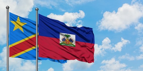 Congo and Haiti flag waving in the wind against white cloudy blue sky together. Diplomacy concept, international relations.