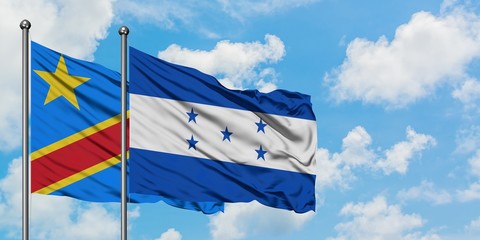 Congo and Honduras flag waving in the wind against white cloudy blue sky together. Diplomacy concept, international relations.