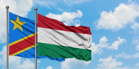 Congo and Hungary flag waving in the wind against white cloudy blue sky together. Diplomacy concept, international relations.