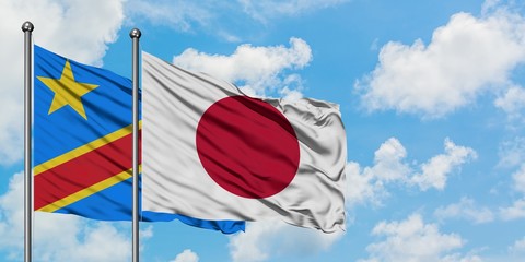 Congo and Japan flag waving in the wind against white cloudy blue sky together. Diplomacy concept, international relations.