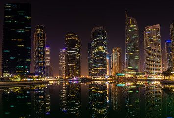 25 October 2019; Jumeirah Lake Towers, Dubai, United Arab Emirates; View of skyscrapers at night with reflections on the lake.dng